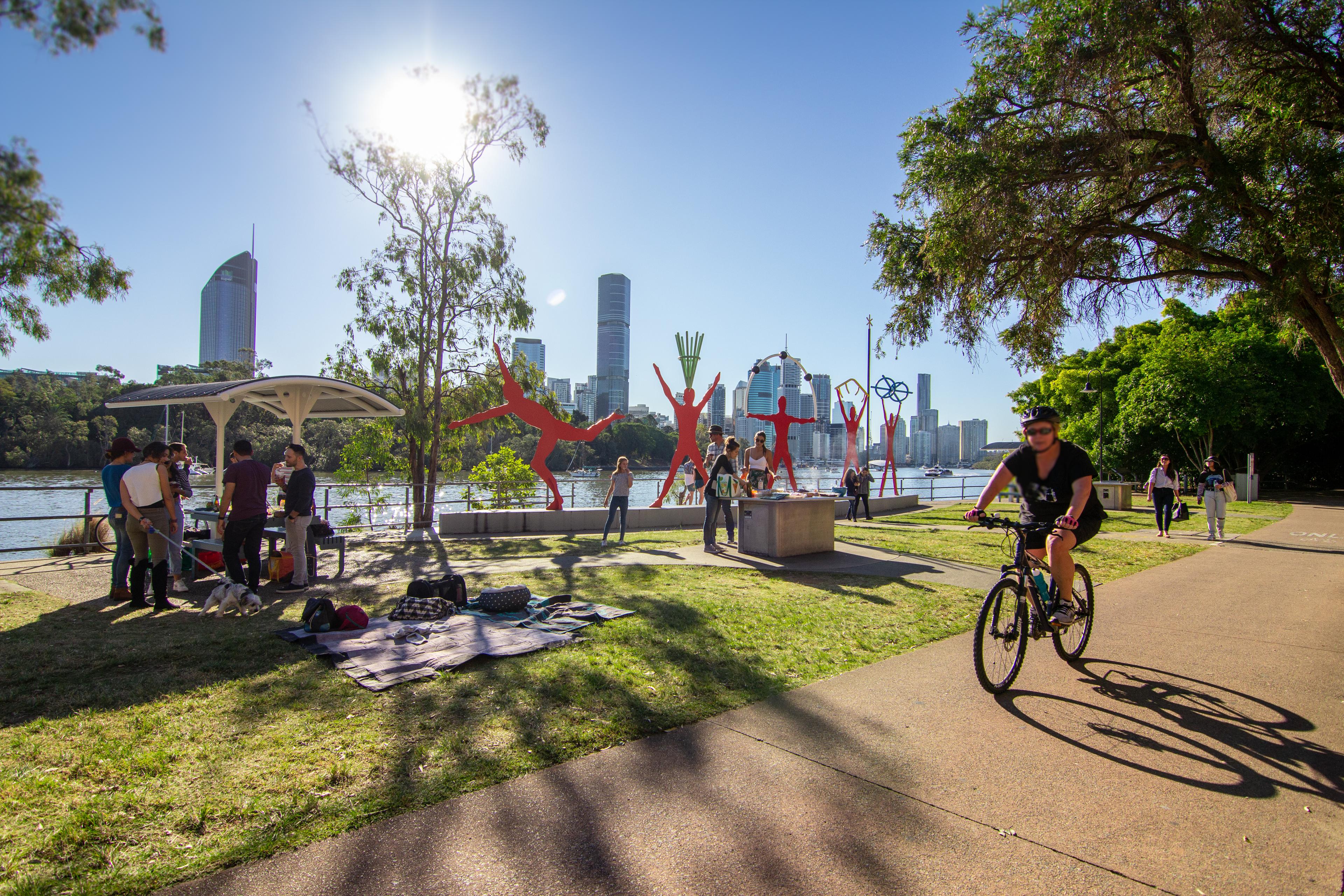 People engaging in various activities at Kangaroo Point Cliffs Boardwalk